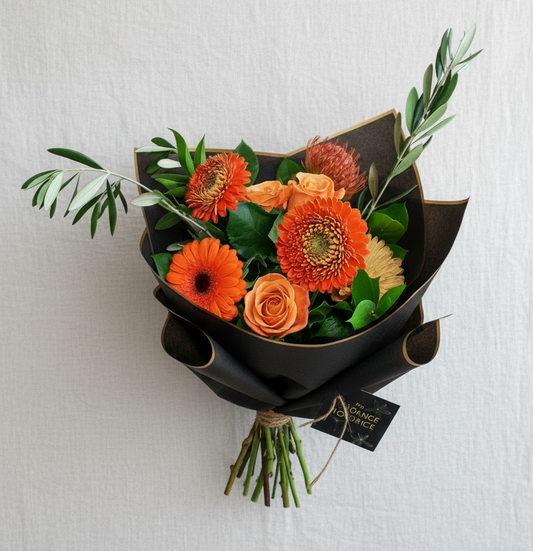 Orange Crush hand‑tied bouquet with bright orange flowers handcrafted in Carleton Place